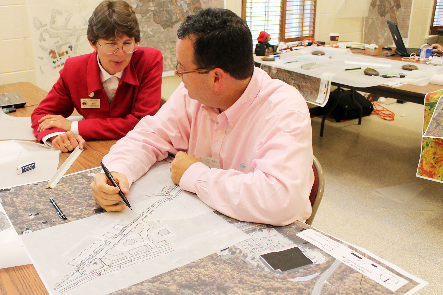 Jenny Plummer-Welker of Calvert County Community Planning and Building goes over maps and data with Wade Walker from the Lawrence Group during the charrette