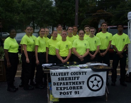 Explorers behind table wearing yellow shirts