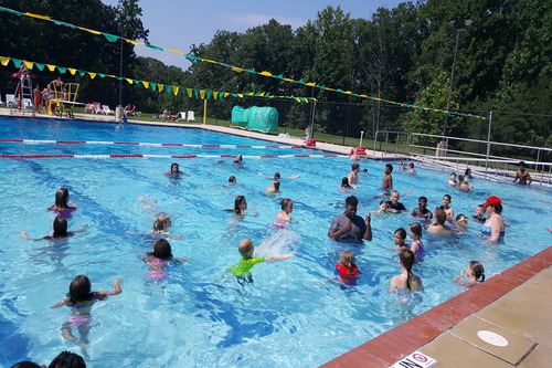 Adults and children playing in Cove Point Pool