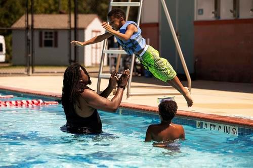 Boy jumping to man at Cove Point Pool