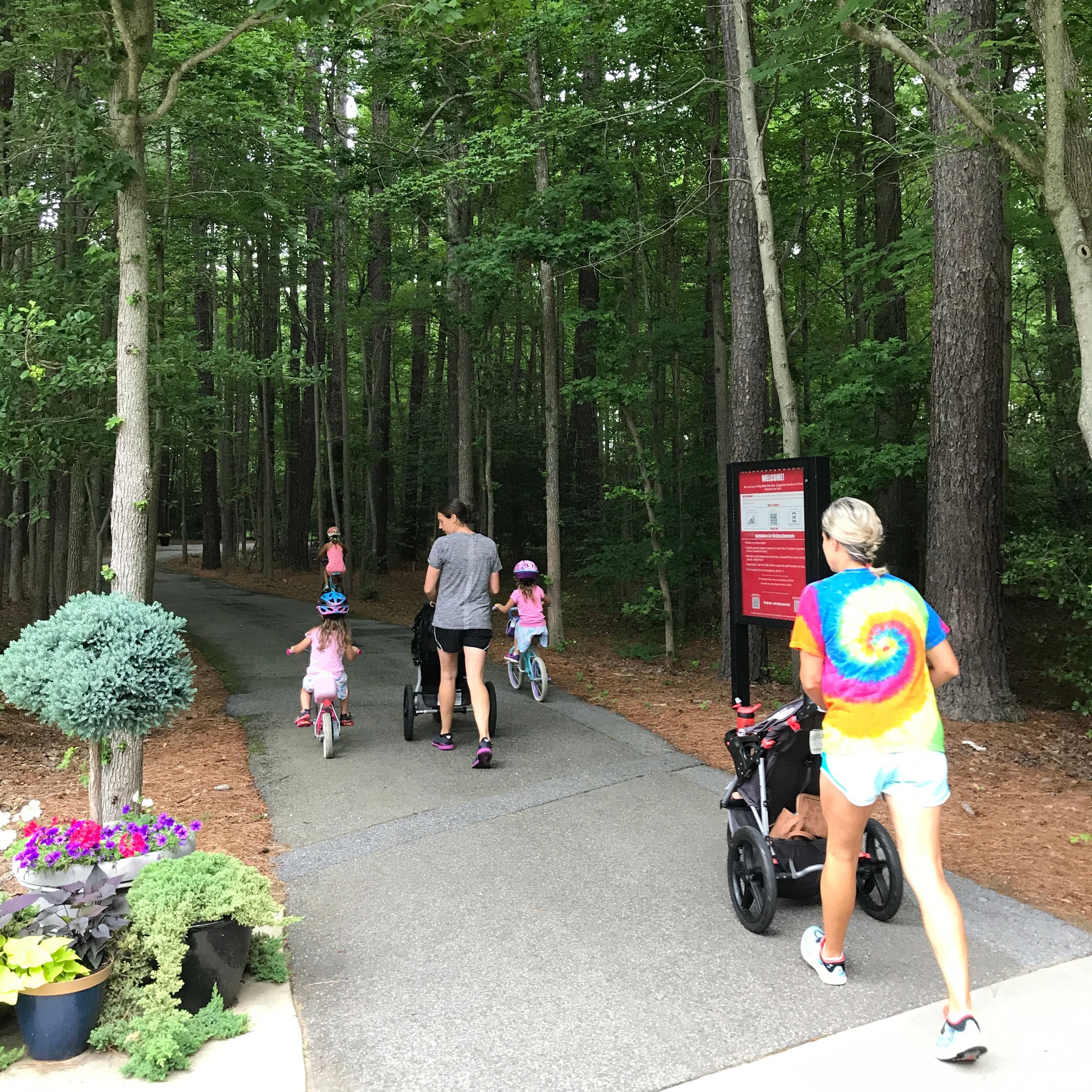 Annmarie Sculpture Garden walking trail with moms and children walking
