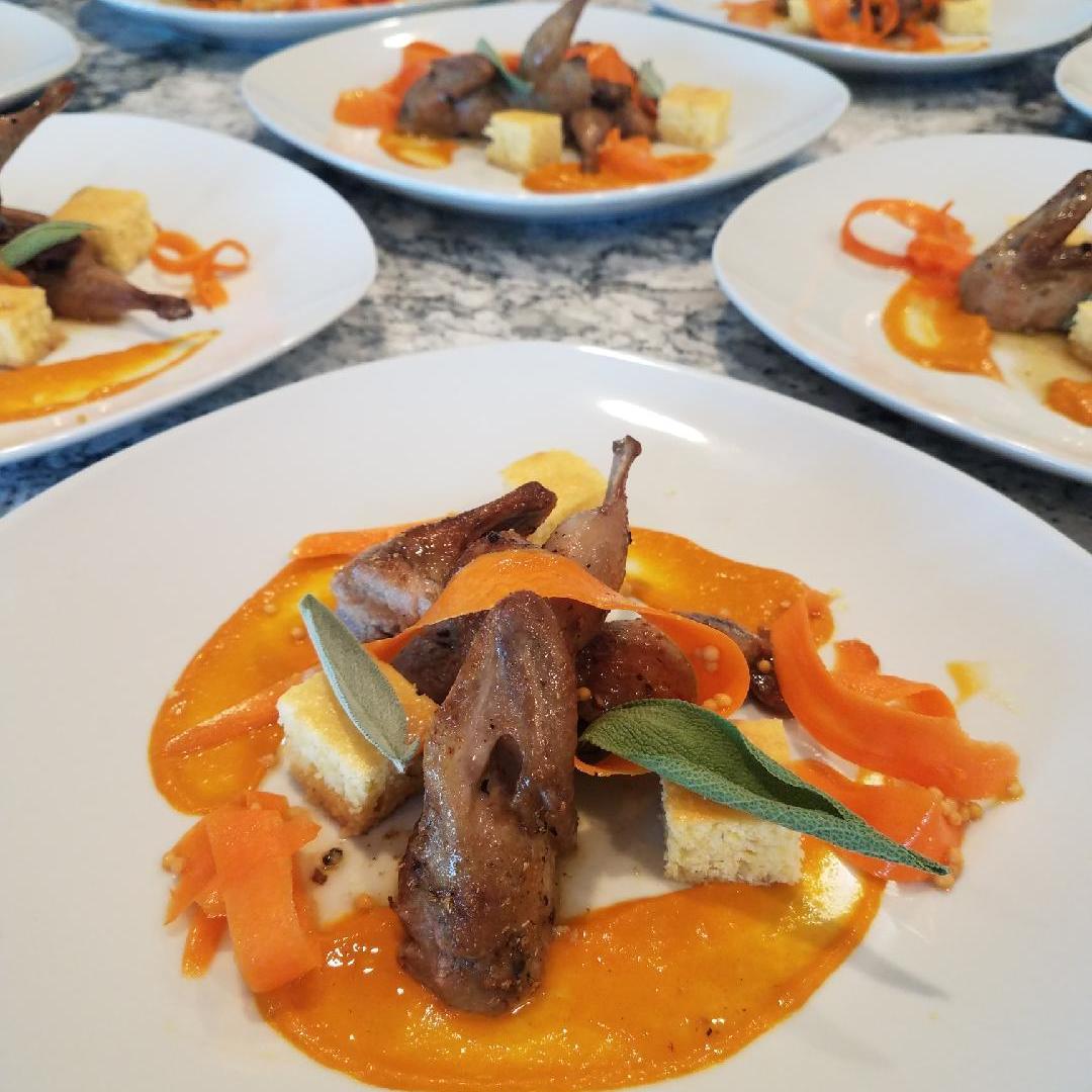 Chicken and carrots plated nicely over sauce