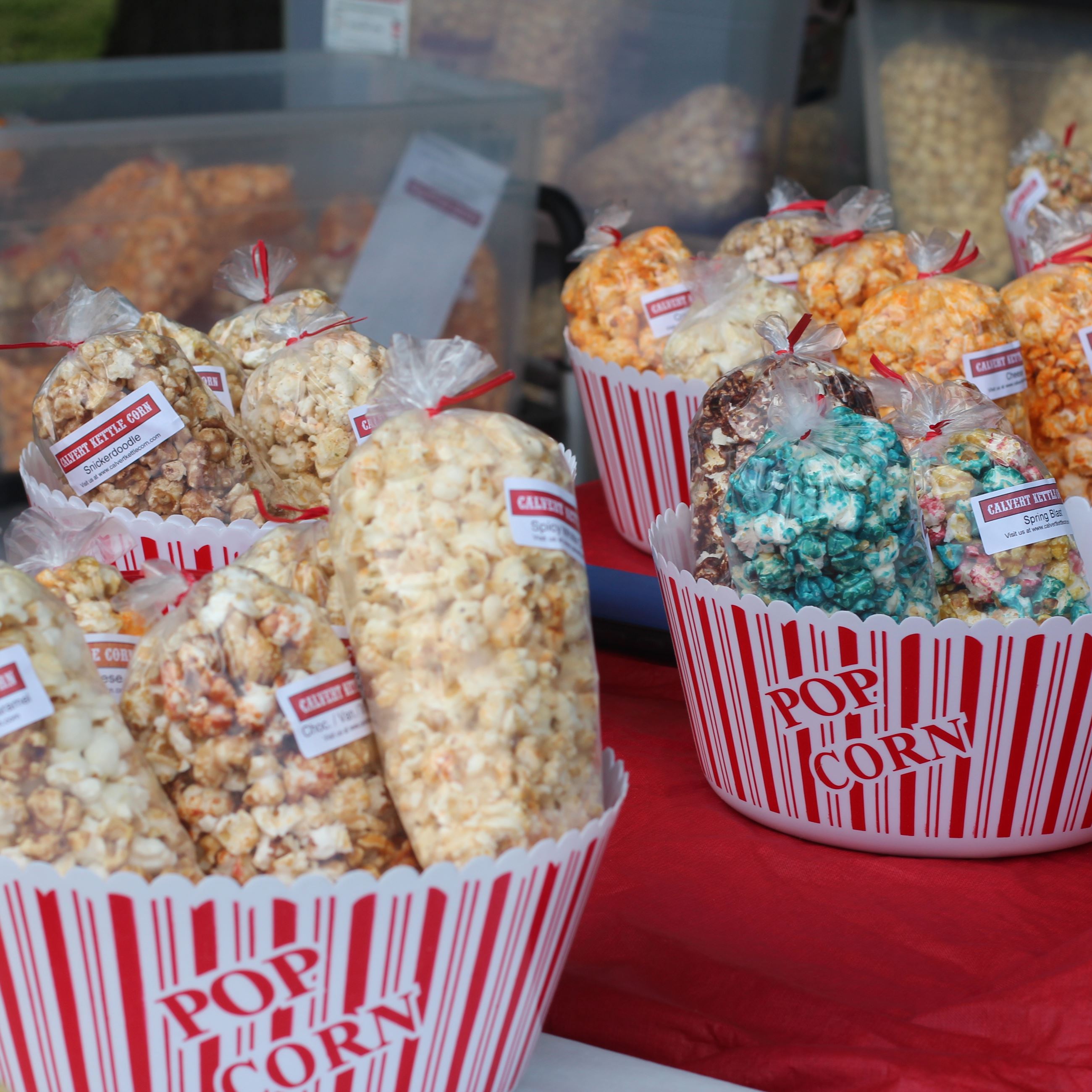 Calvert Kettle Corn popcorn buckets with a variety of kettle corn in bags