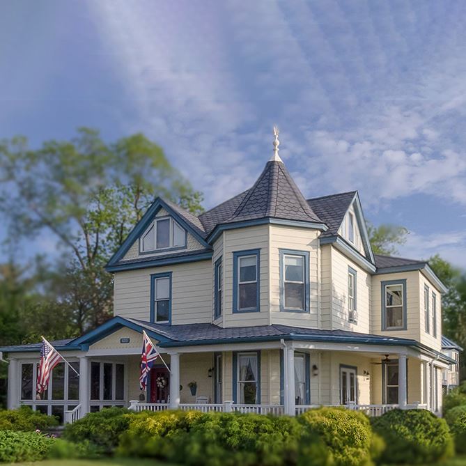 Blue skies and shrubbery surrounding the Solomons Victorian Inn