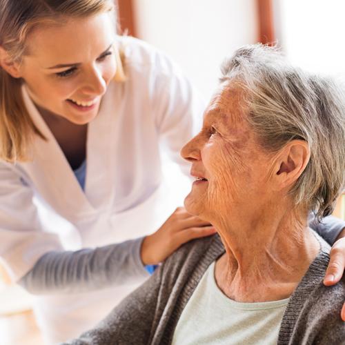 Nurse tending to senior woman