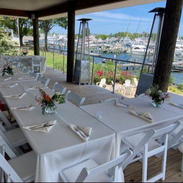 Tables set up on deck overlooking the water