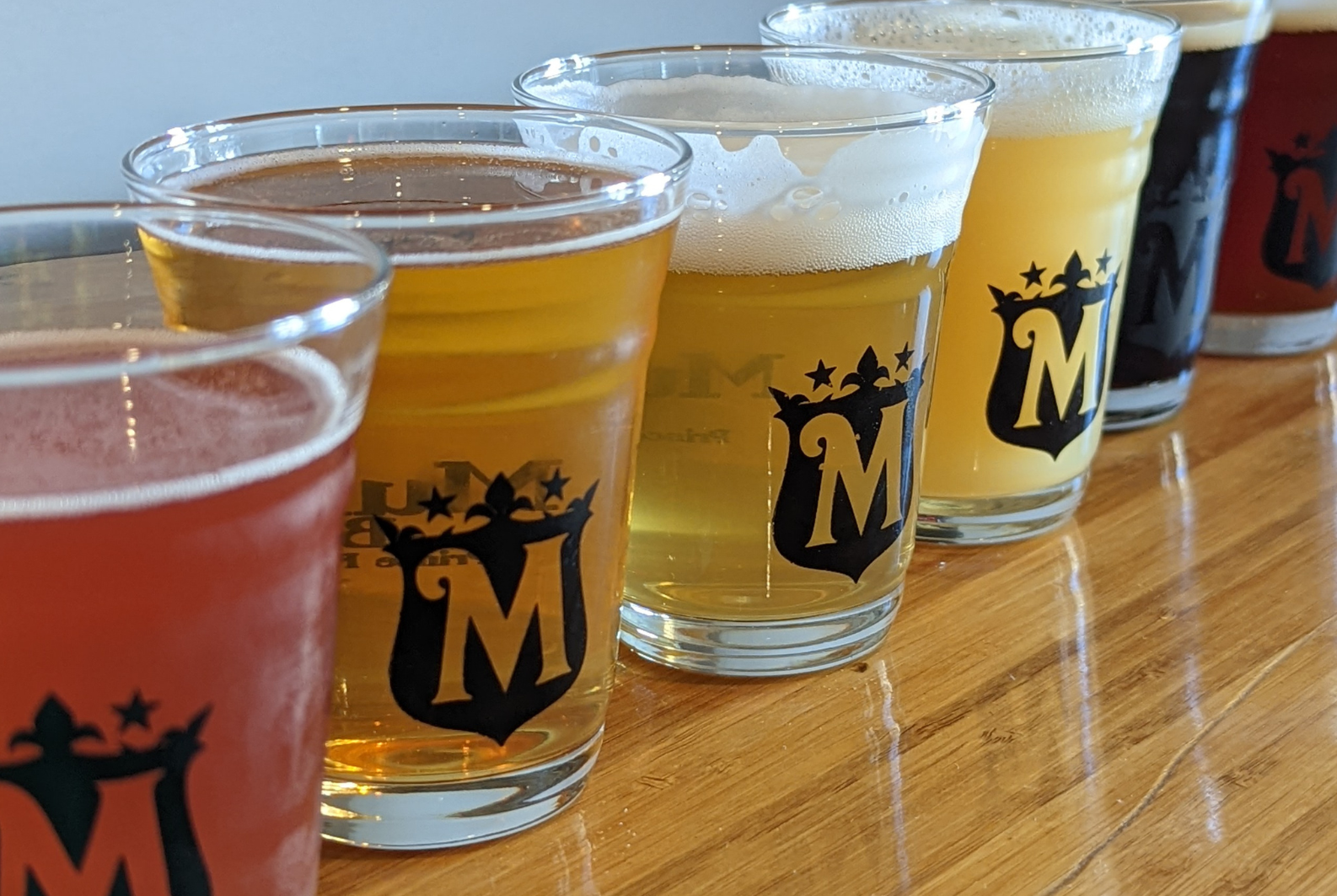 Glasses of beer lined up on a table