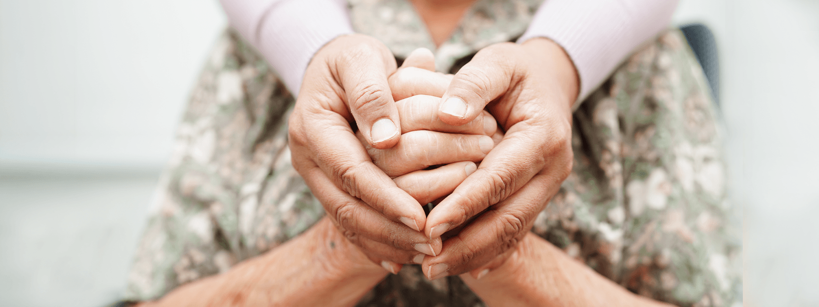 Caregiver hands holding hands