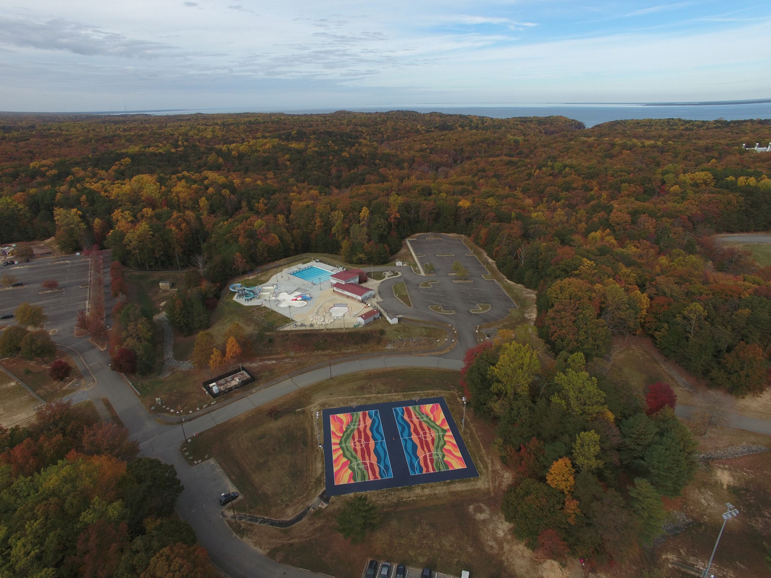 Basketball court mural, swimming pool complex, forest, and Chesapeake Bay